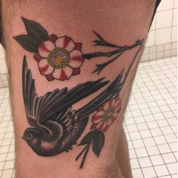 腿部彩绘花朵与黑灰色鸟儿纹身图案